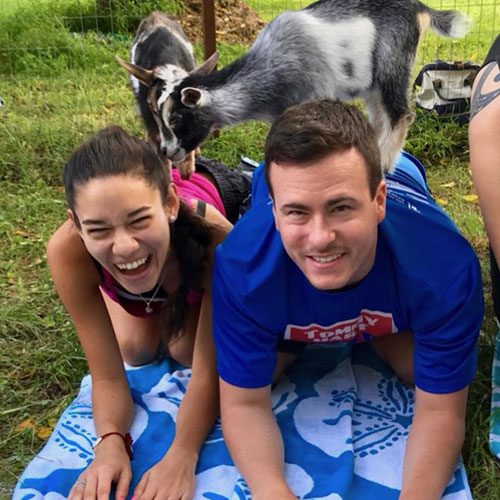 Goat yoga couple with goats